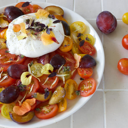 Snelle tomatensalade met burrata en eetbare bloemen